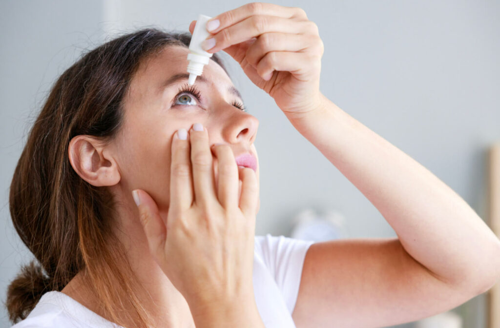 Closeup view of young woman applying eye drops for dry eyes. Ilux dry eye treatment is an effective way to reduce the symptoms of dry eye syndrome.