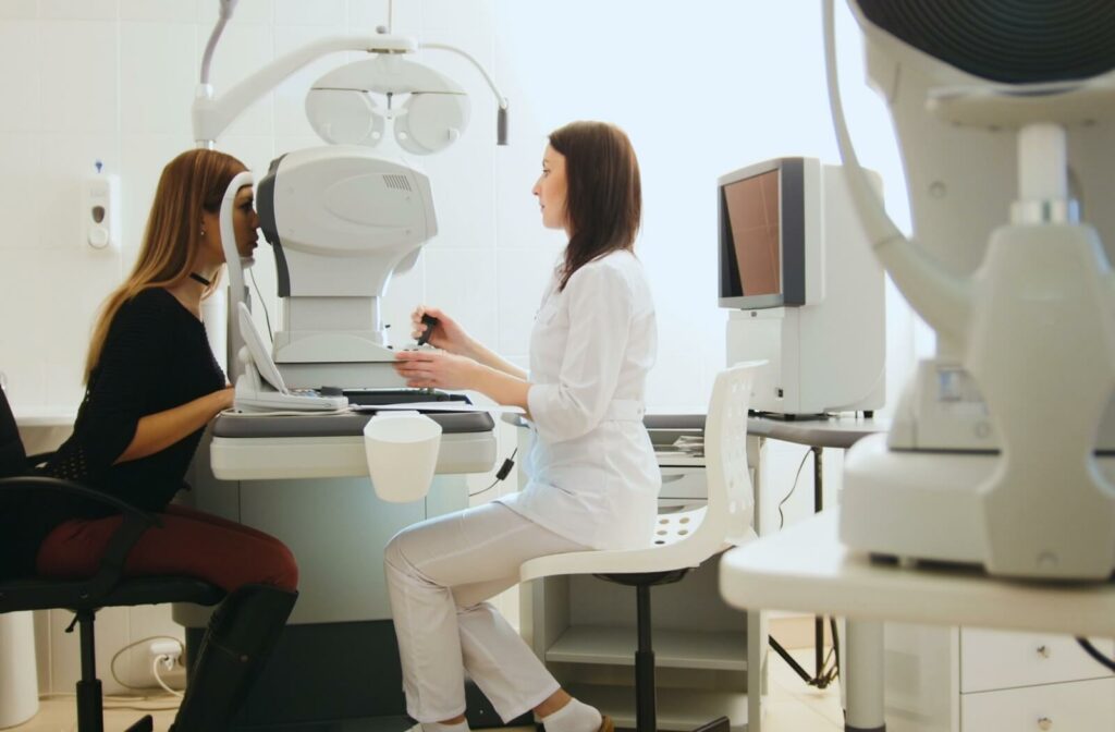 An eye doctor using a tonometer to measure a patient's eye pressure to check for early signs of glaucoma.