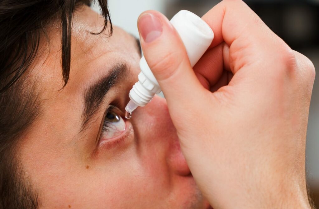 Close-up of person applying eye drops to relieve irritation and redness from dry eye symptoms