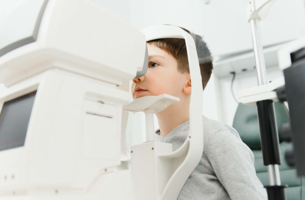 Boy undergoing eye exam at optometry clinic.